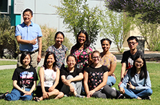 Group photo of student sitting on grass.