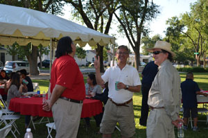 People talking at BBQ.