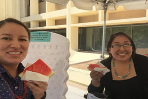 Girls holding watermelons slices.