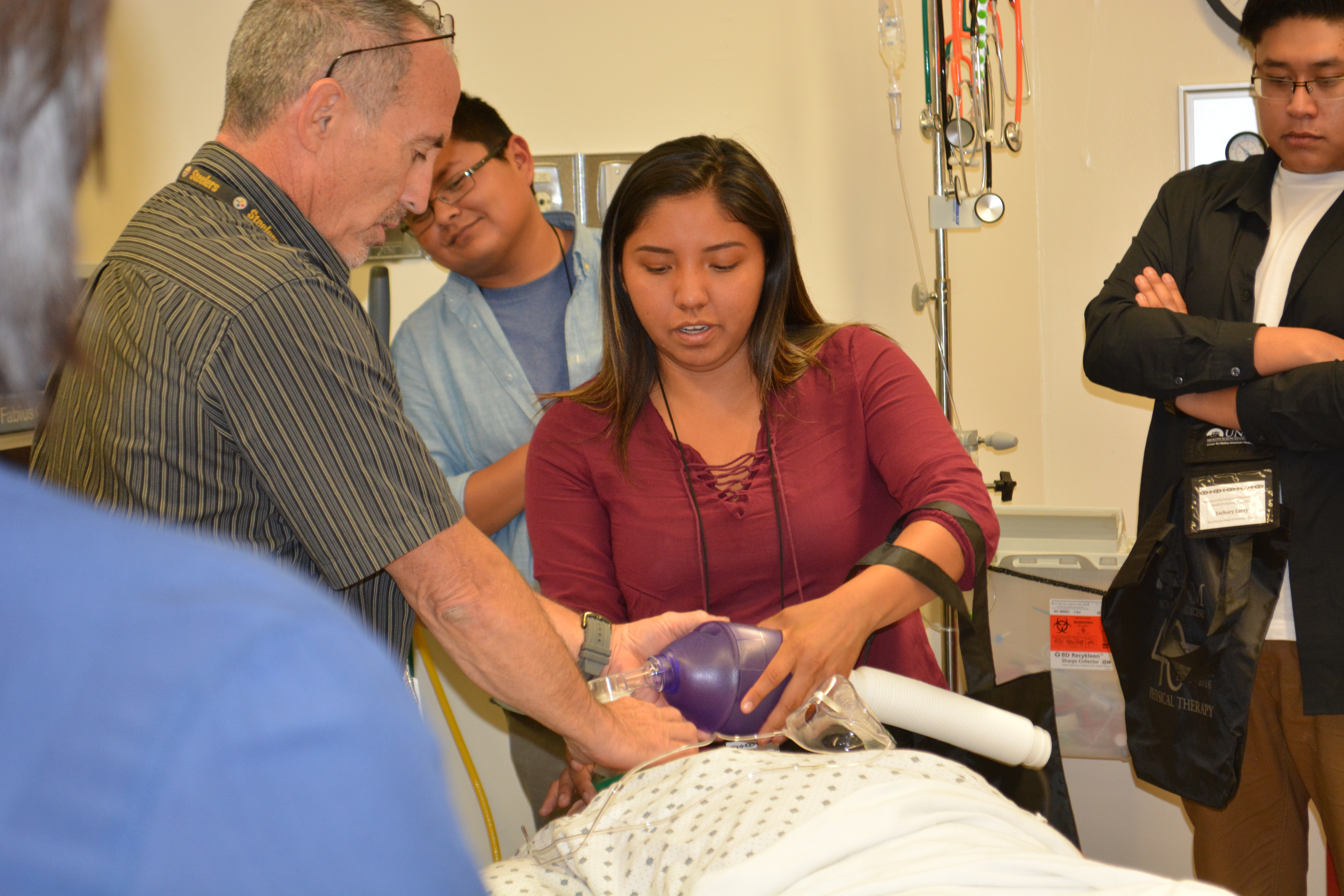 Participant doing hands-on activity - intubating dummy patient.