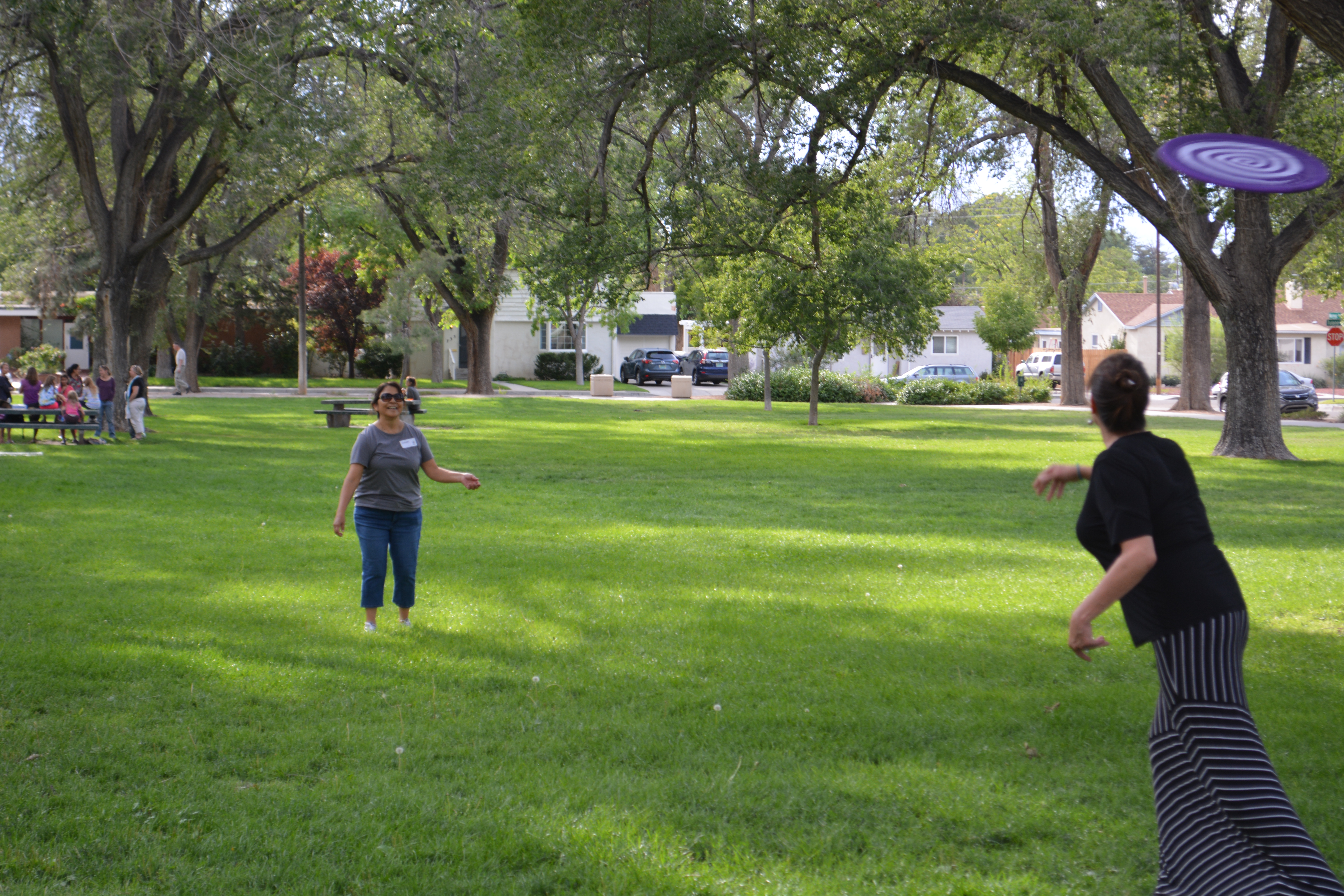 Two ladies playing frisbee.