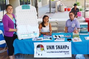 Student with table at the fair.