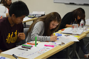 SPA students writing at tables.