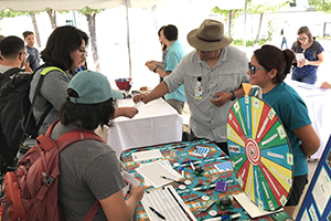 Community members visiting table.