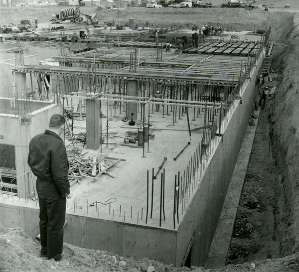 Man overlooking the construction of a new building