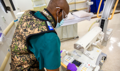 Anesthesiologist working with equipment.