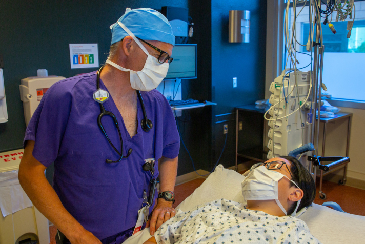 Anesthesiologist with patient in ICU