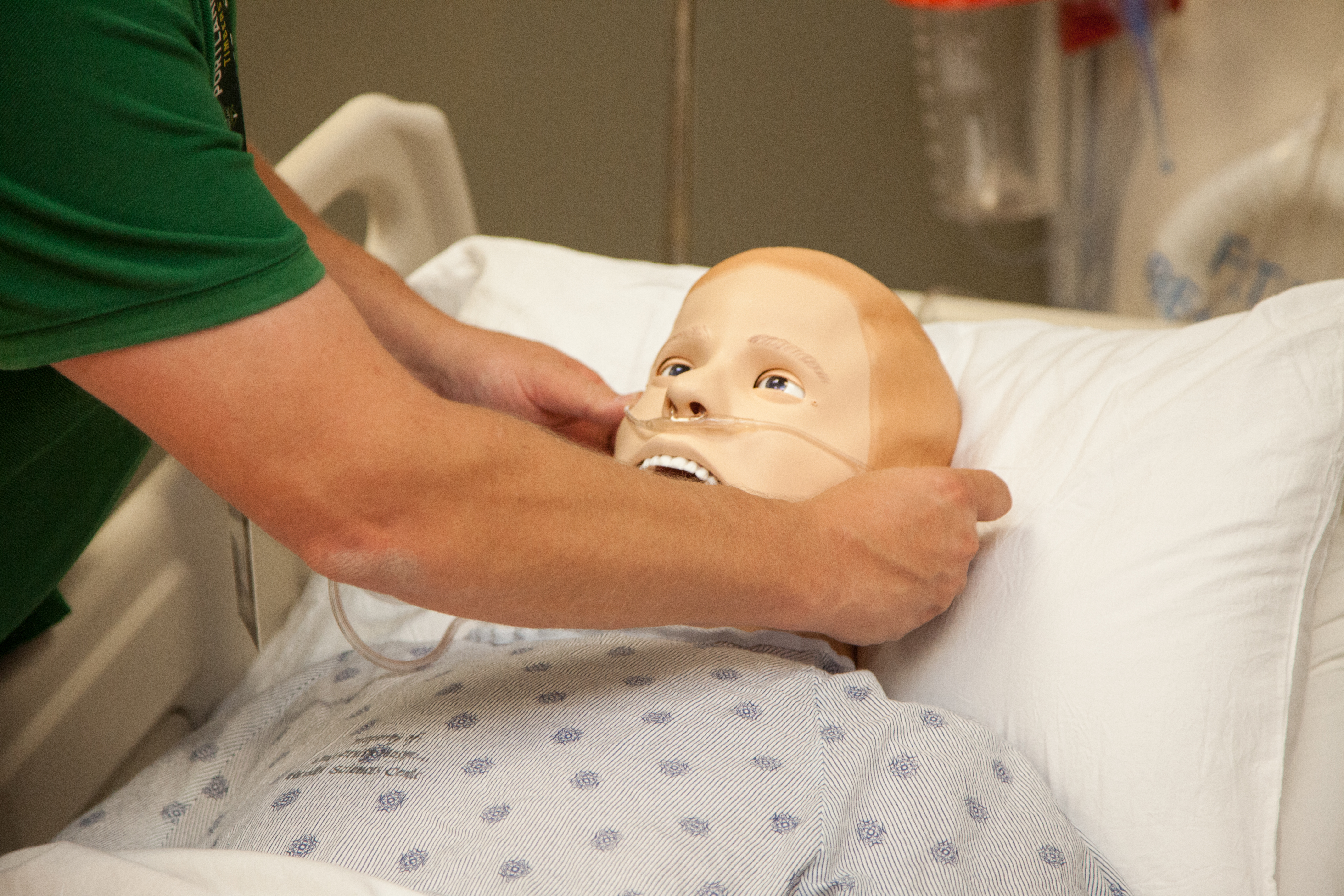 person placing oxygen on dummy