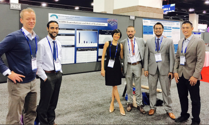 fellows with poster at conference
