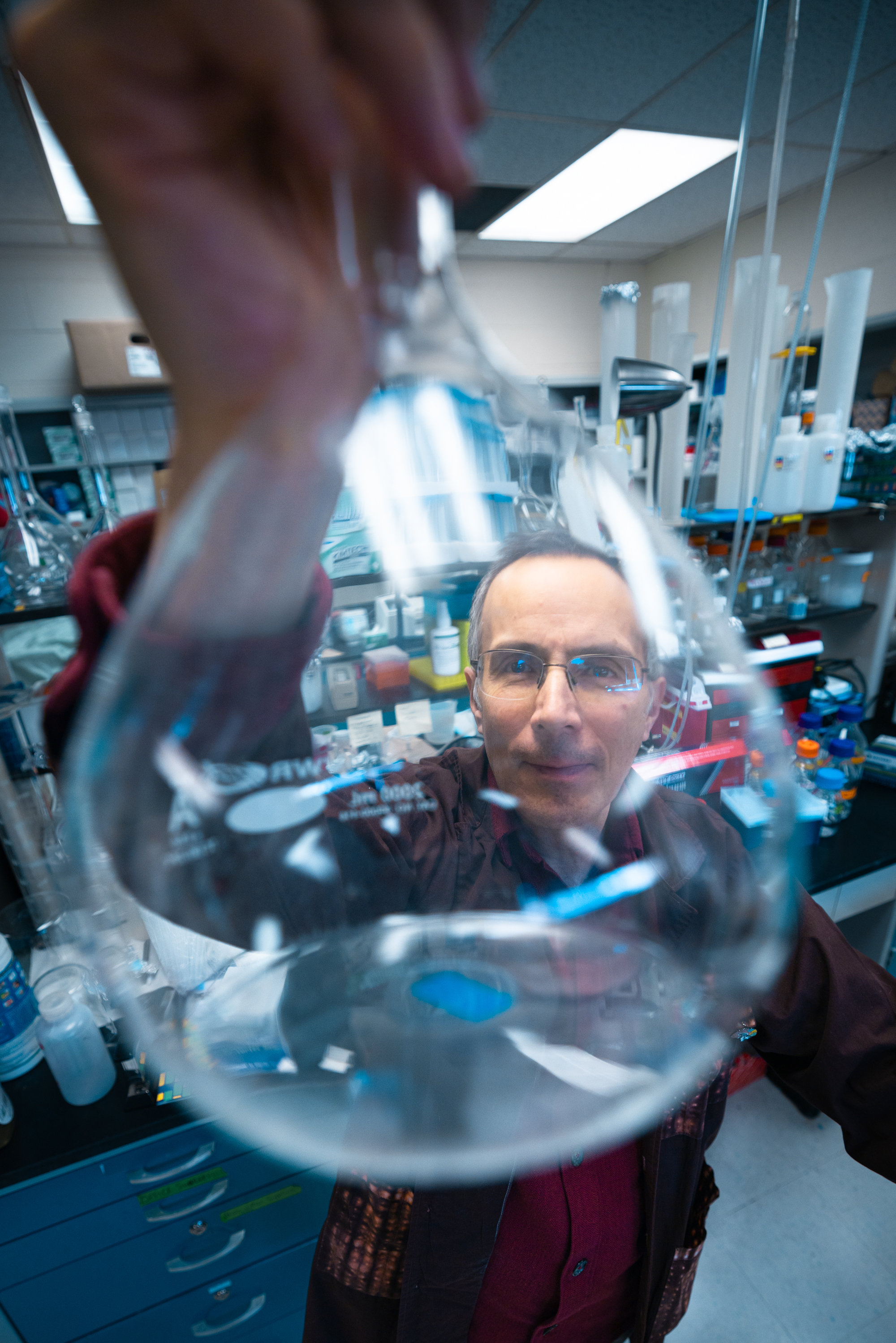 NMARC Director Fernando Valenzuela holding up a beaker to the camera