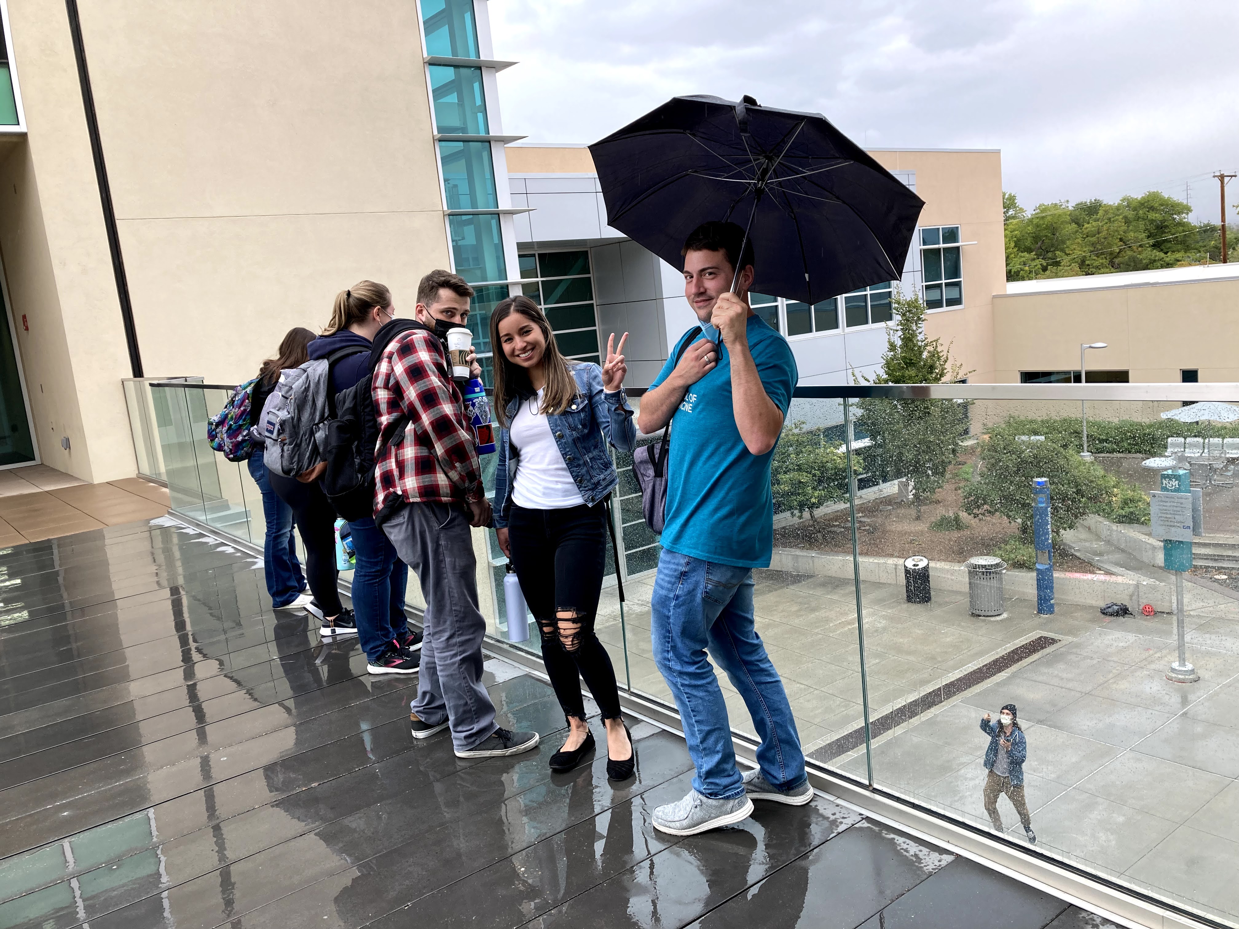 students on bridge between Doenici Center wings