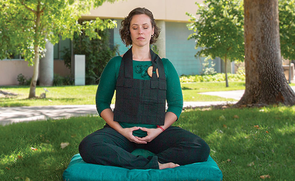A woman meditating outdoors
