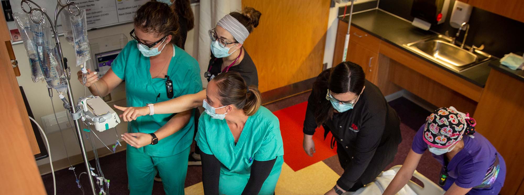 Nursing students working together on a patient