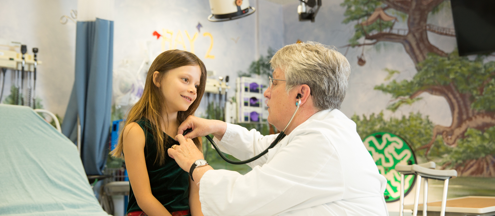 A pediatric doctor examining a patient with a stethoscope