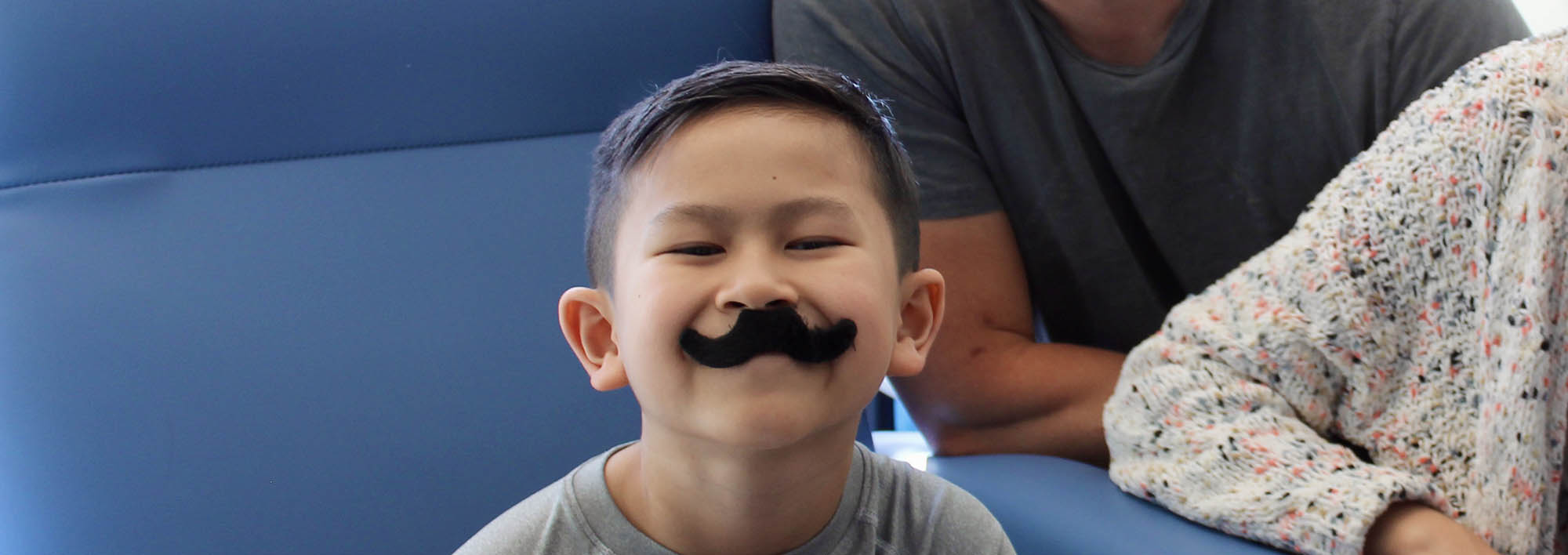 Jackson smiling with a fake moustache