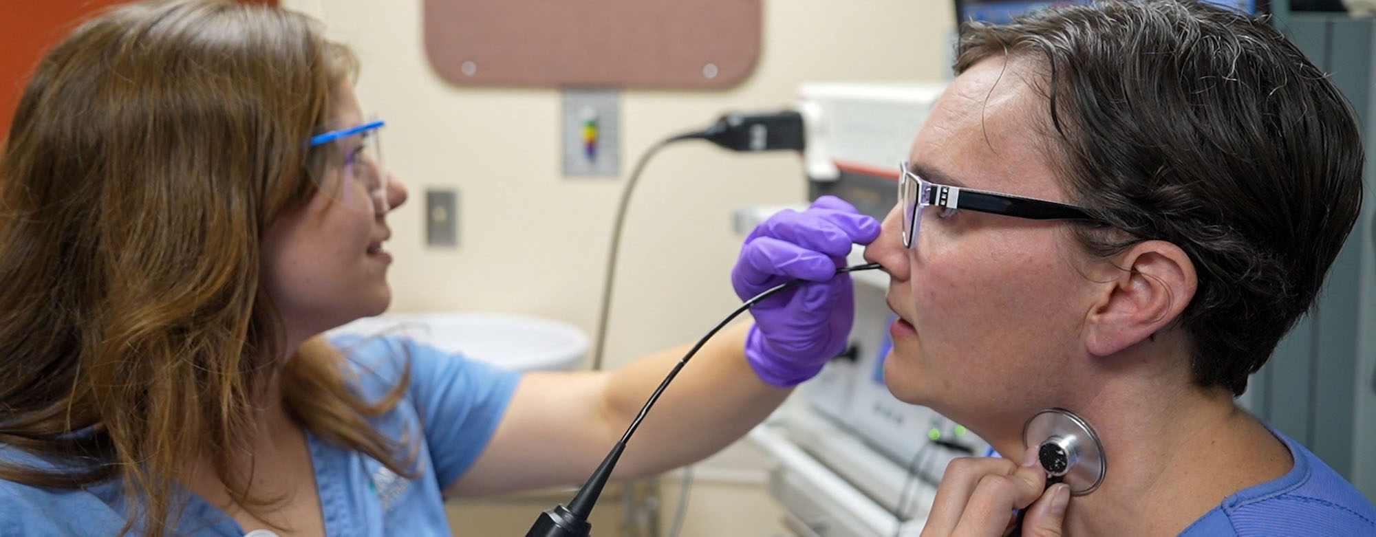 A speech pathologist conducting a test on a patient