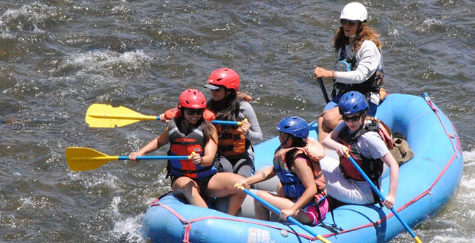 Members of the UPN program ride a white water raft