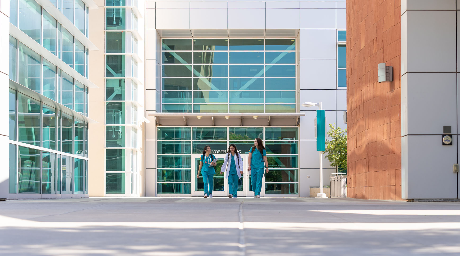 student in outside Domenici building
