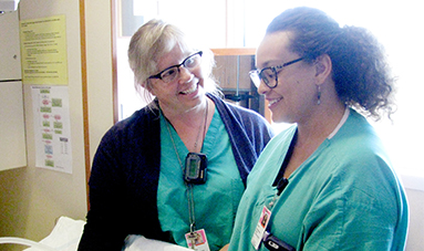 Nurse examining pregnant patient.