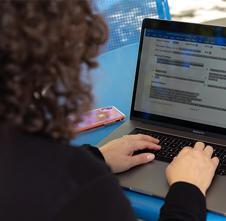 Woman working on laptop.