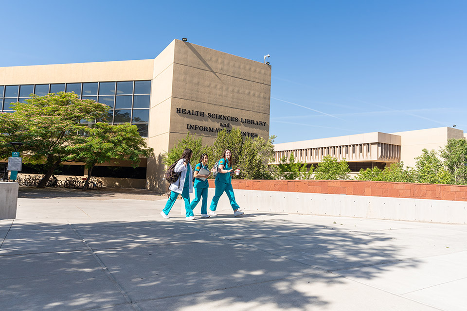 Students walking  near front of HSC Library.