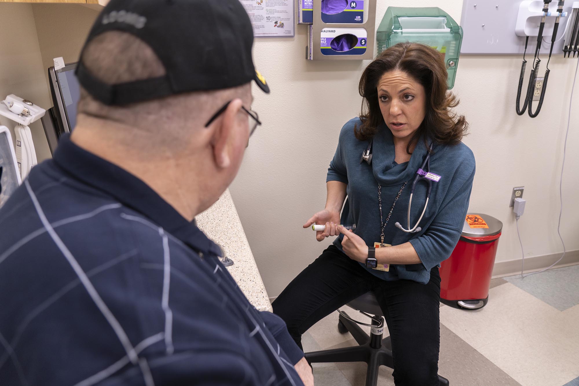 Alumna Gretchen Ray, PhC consulting a patient.